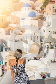 Young girl admiring stunning Oia architecture in Santorini