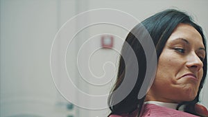 A young girl is admitted to a dentist. During this time she opens her mouth and understands the doctor.