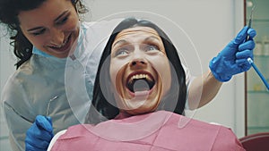 A young girl is admitted to a dentist. During this time she opens her mouth and understands the doctor.