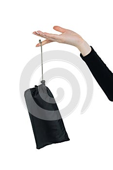 Young girl advertises a black bag. A hand holds a product on a white background