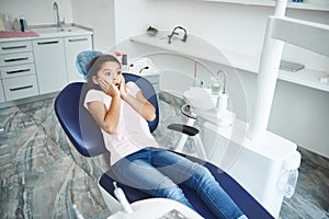 Young girl is afraid of dental procedures