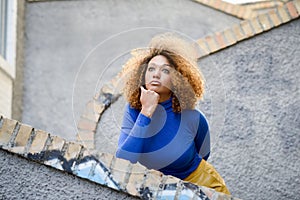 Young girl with afro hairstyle in urban background