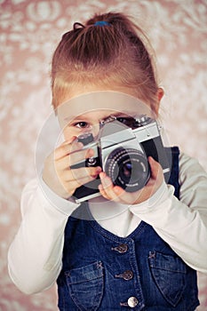 Young girl with analogue camera