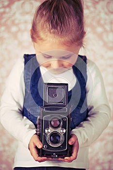 Young girl with analogue camera