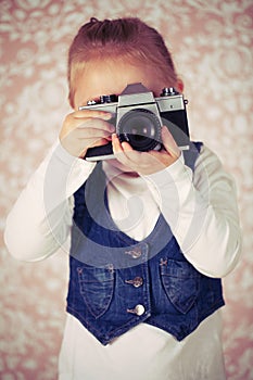 Young girl with analogue camera