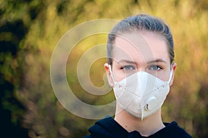 Young girl with anti-virus anti-smog mask on her face