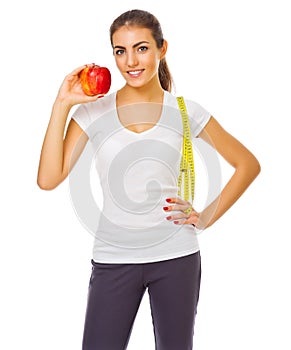 Young girl with apple and measurement tape