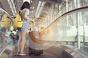 Young girl asian traveler holding phone with carrying