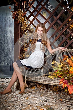 Young girl in autumn fairy garden. Fall