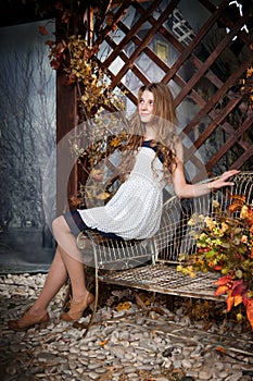 Young girl in autumn fairy garden. Fall