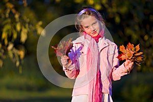 Young girl with autumn leaves