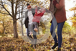 Young Girl On Autumn Walk With Parents