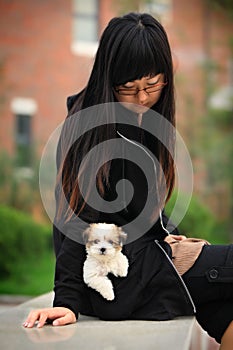 Young girl and baby dog