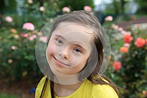 Young girl on the background of roses