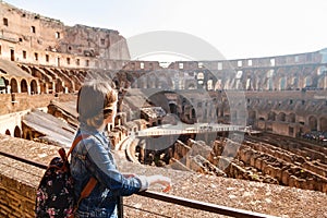 Young girl with backpack exploring inside the Coliseum