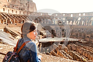 Young girl with backpack exploring inside the Coliseum