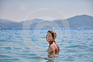 Young girl bathing in lake Attersee