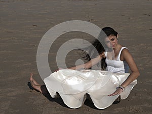 Young girl on beach with giant shell