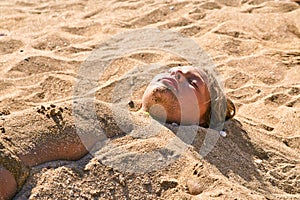 Young girl at the beach in sandbed