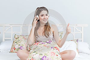 The young girl in bed listening to music