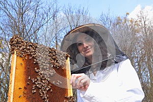 A young girl beekeeper in apiary