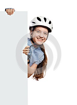 Young girl in bicycle helmet holds vertical white blank, Isolated on white.