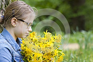 Young girl with big bouquet of spring flowers