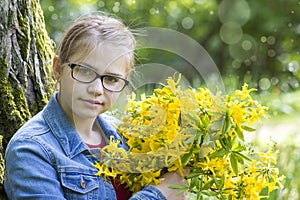 Young girl with big bouquet of spring flowers