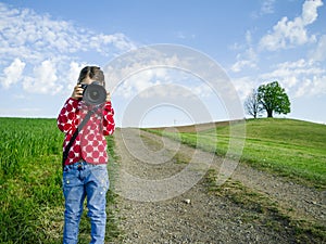 Young girl with big camera in rural Switzerland