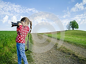 Young girl with big camera in rural Switzerland