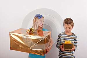 Young girl with big gift box gloating over her brother and his s