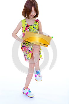 Young girl with big round box.