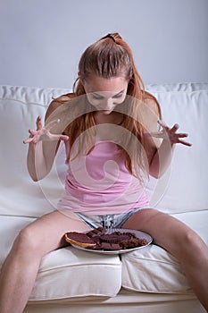 Young girl binging on sweets