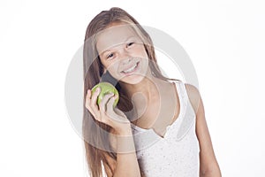 Young girl is biting a green apple.
