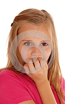 Young girl biting her fingernails.