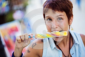 Young girl bitting an ice lolly