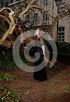 Young girl in a black dress in the park