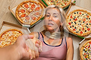 A young girl with blond hair is holding her boyfriend& x27;s hand. There is a lot of pizzazz around her head. Colorful pizza.