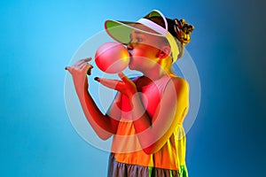 Young girl blowing bubble gum