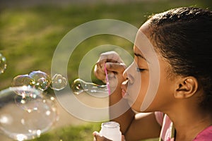 Young Girl Blowing Bubbles