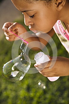 Young Girl Blowing Bubbles