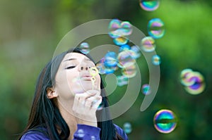 Young girl blowing bubbles