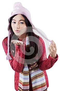 Young girl blowing wind on hand