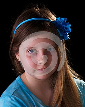 Young girl in blue with flower in her hair