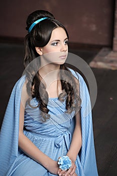 Young girl in blue vintage dress late 19th century