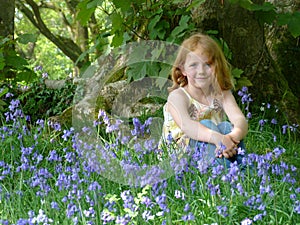 Young girl in bluebell wood