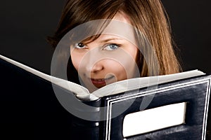 Young girl and book in dark