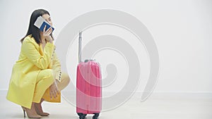 Young girl is bored standing with her suitcase in the airport, because her trip was canceled.
