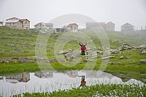 Young girl bouncing by the pond in Koçdüzü Plateau