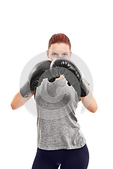 Young girl with boxing gloves blocking